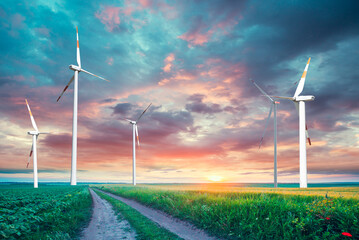 Wind mill power energy farm generator renewable sustainable field on suset, environment eco system technology industry ecology electricity power propeller turbine clean carbon. High quality photo