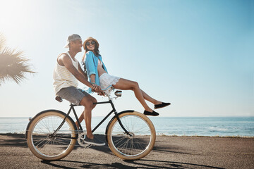 Happy, couple and ride bicycle in nature for travel, adventure and bonding together. Space, people...