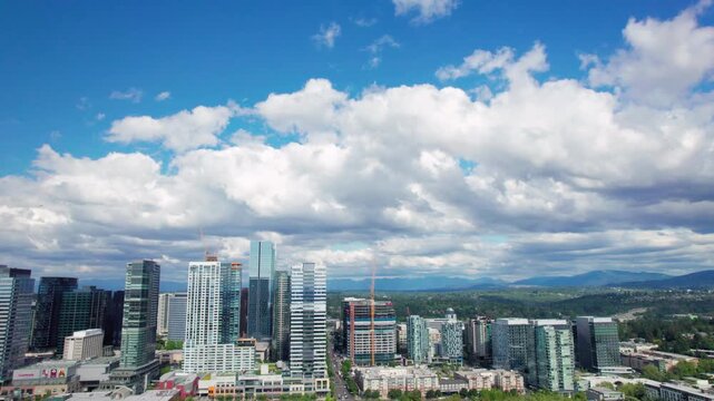 Drone Panning Modern City Buildings with Fluffy Clouds