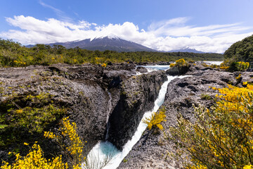 Puerto Varas, Chile: The famous Petrohue waterfall situated near Puerto Varas in Lake District of Chile with Osorno volcano covered with cloud on sunny day