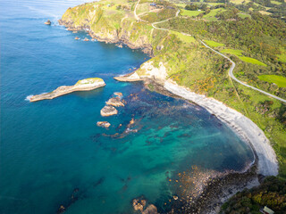 Chiloe Island, Chile: Aerial view of the beach by cliffs by pacific ocean in Pu&ntilde;ihuil near Ancud in Chiloe island in the Lake District in Chile.