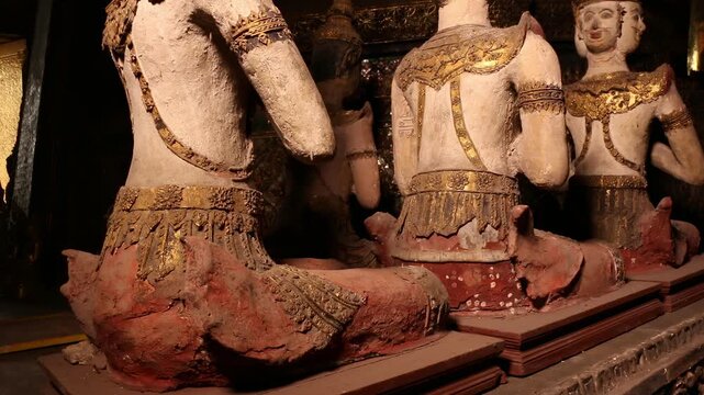 Ancient Thai angel statues in praying gesture (Wai) at  Wat Paichayon Ponsep, Thailand.