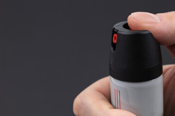 Man holding pepper spray for self defense close up