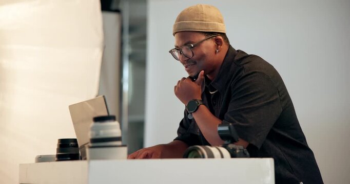 Photographer, man and thinking in studio with laptop, retouching image and creative idea for magazine. Happy, black person or cameraman in agency with computer, media project and editing photography.