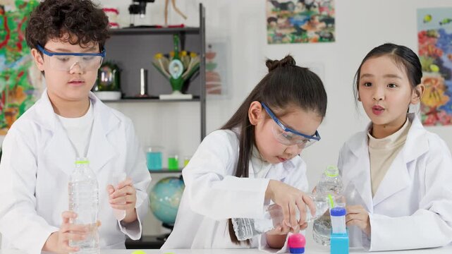 Asian Students Conduct Bernoulli Principle Science Experiment with Water Bottles and Balls