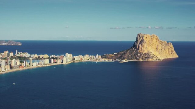 Scenic coastal view of calpe with iconic rock formation at sunrise