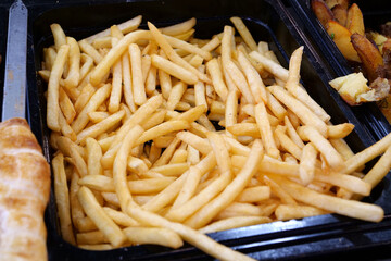 French fries in fast food restaurant. Fried potatoes