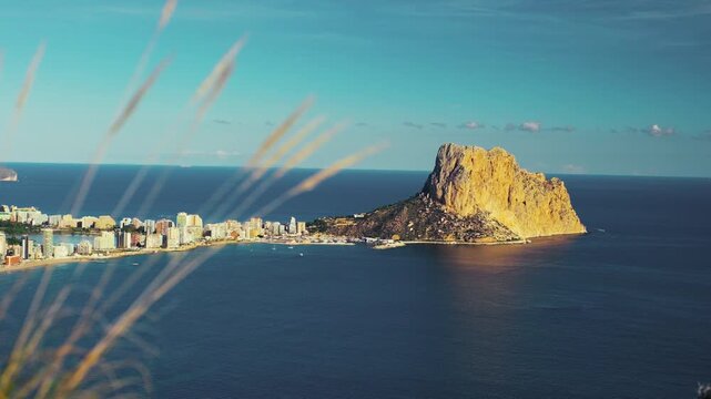 Scenic coastal view of calpe with iconic rock formation at sunrise