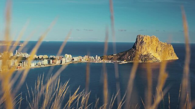 Scenic coastal view of calpe with iconic rock formation at sunrise