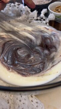 Melted Chocolate Blending with Cream for Rich Chocolate Brownie Recipe