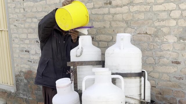 Man Pouring Milk into Container at Dairy or Market
