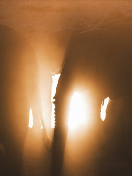 Aerial view of a blinding light piercing through the vast expanse of nothingness, highlighting the contours of the landscape, Etosha National Park, Namibia.