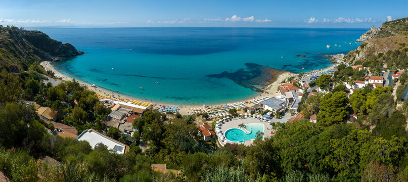 Panoramic aerial view of Grotticelle beach, located on the Costa degli Dei, Calabria, Italy. On the right, on the horizon, is the promontory of Capo Vaticano, overlooking the crystal-clear sea.