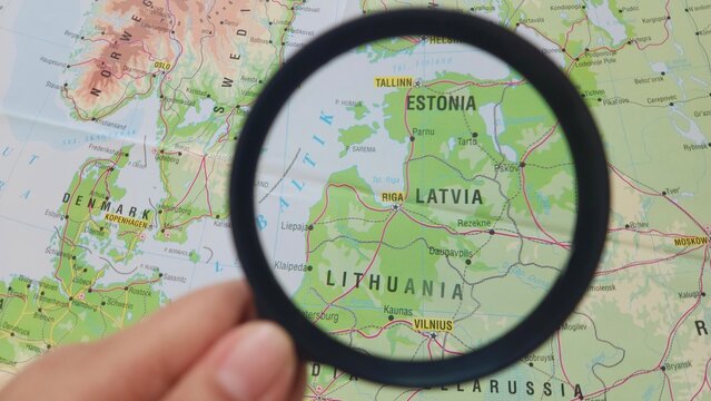 View of Latvia, officially the Republic of Latvia, is a country in the Baltic region of Northern Europe, on a geographical map of Europe, seen using a magnifying glass