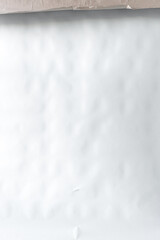 Obraz premium Minimalist white matte textured backdrop. White crumpled paper texture background. Abstract light wrinkled paper surface with subtle highlights.