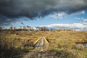 Obraz premium A small village in autumn on the other side of the river