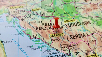 Naklejka premium View of Sarajevo, Capital city of Bosnia and Herzegovina, on a geographical map of Europe, marked with red push pin
