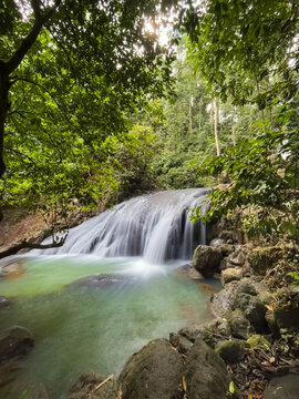 Beautiful Curug Bibijilan waterfall with emerald green water in Sukabumi, West Java, Indonesia.