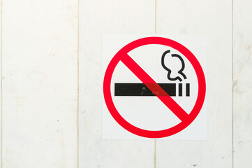 No smoking sign on the concrete building wall, the sign indicates that smoking is prohibited in this area