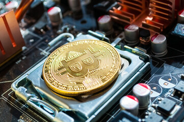 Golden bitcoin among the electronic computer details. Business concept of digital cryptocurrency and bitcoin mining