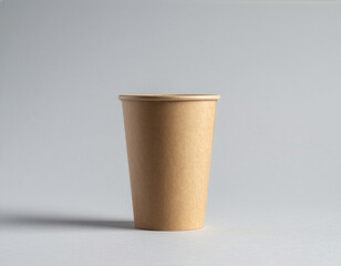 Brown paper coffee cup mockup on gray background with studio lighting
