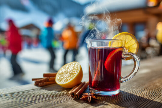 Bright mulled wine sits on a wooden counter at a ski resort. People in colorful clothes walk by, enjoying the winter weather and skiing