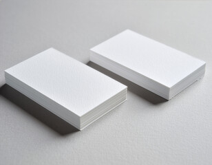 Stack of blank white business cards mockup on a gray surface