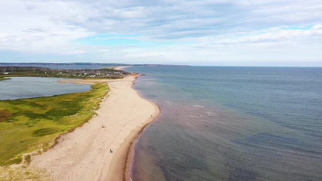 Aerial drone footage of the beautiful beach in Summerside, Prince Edward Island PEI in Canada showing a Birds Eye view of the beach front and ocean on a sunny day in the autumn time