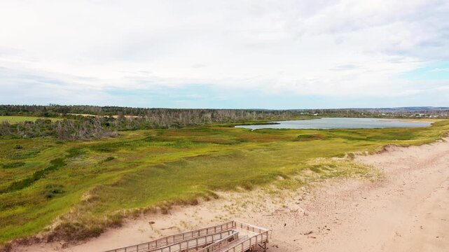Aerial drone footage of the beautiful beach in Summerside, Prince Edward Island PEI in Canada showing a Birds Eye view of the beach front and ocean on a sunny day in the autumn time