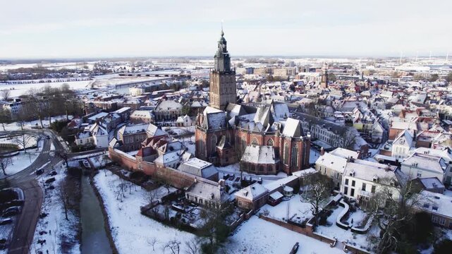 Contrast blue cast over medieval Hanseatic Dutch tower town Zutphen in the Netherlands covered in snow after a blizzard snowstorm