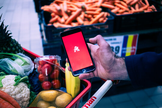 person shopping for groceries in Auchan supermarket