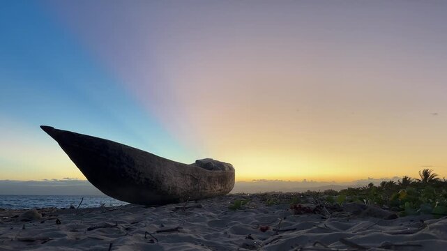 Traditional Malagasy boat on the beach after sunset in Maroantsetra. Madagascar.