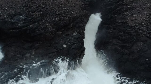 Drone shot of Atlantic waves breaking over volcanic rock on the Isle of Lewis.