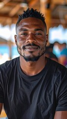 Obraz premium a black male model man wearing a black shirt standing in the beach bar