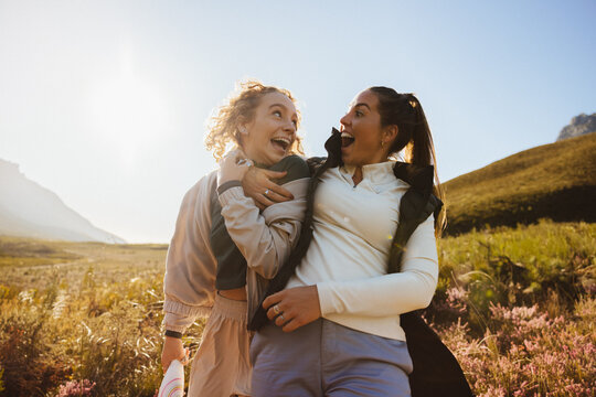Two friends laughing outdoors together