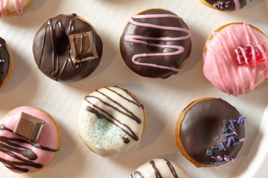 Mini donuts covered in chocolate on a white background. Close-up