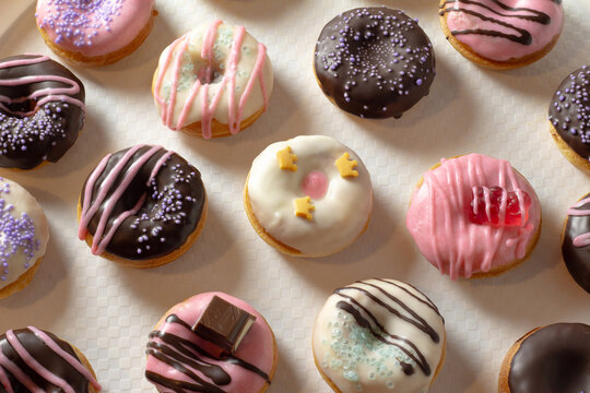 Mini donuts covered in chocolate on a white background. Close-up