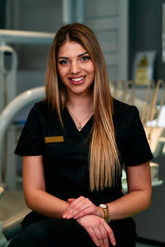 Friendly Medical Professional in Scrubs Posing for Portrait in Modern Clinic Environment