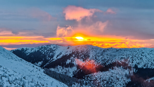 Breathtaking golden hour sunset illuminating majestic snow-capped mountains in Chopk maountains