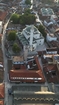 High-angle drone perspective flying over the historic Gazi Husrev-Beg mosque and the old town Bascarsija in Sarajevo