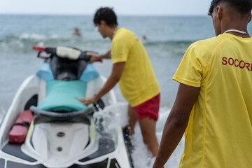 Lifeguards preparing rescue watercraft for emergency response