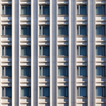 View of a modern building facade with repeating patterns of windows and vertical columns, showcasing a symmetrical architectural design, R&Auml;&laquo;ga, Latvia.