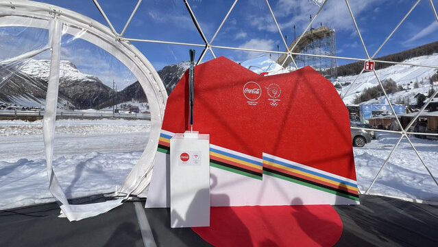 Livigno, Italy - February 12, 2026: Official Olympic torch on display at Milano Cortina 2026 Winter Games event pavilion in the alpine resort of Livigno