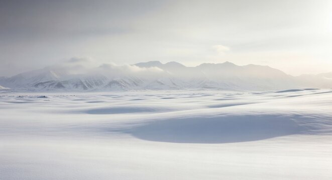 Snow-covered plain with distant mountains under soft, diffused light. Minimalist winter landscape with gentle curves and muted tones conveying silence.