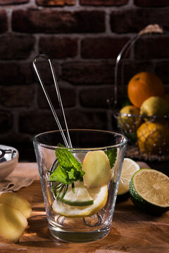 Preparing detox water with mint, rosmary, ginger and limes