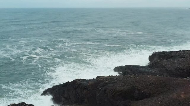 Drone shot of Atlantic storm waves rolling across the headland of Lewis.
