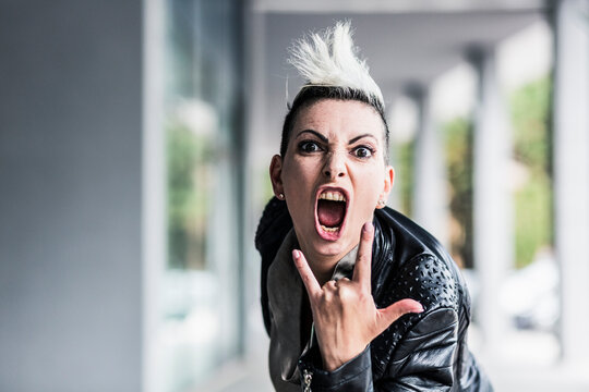 Portrait of screaming punk woman at an arcade