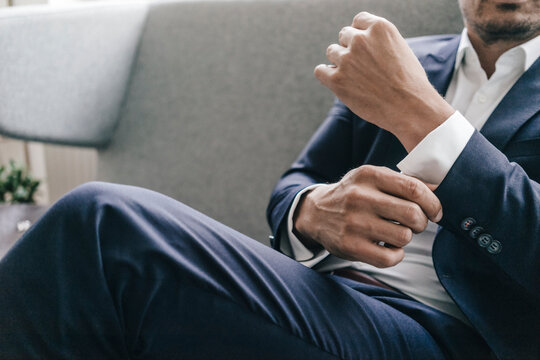 Close-up of businessman adjusting his sleeves
