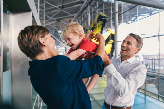 Small boy being happy upon his business mother's arrival at the airport