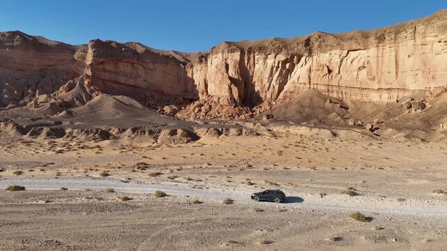 Aerial View Of Family Car Driving Desert Paran

Drone footage captured on February 12 2026 showing vehicle crossing vast Paran desert landscape Israel

